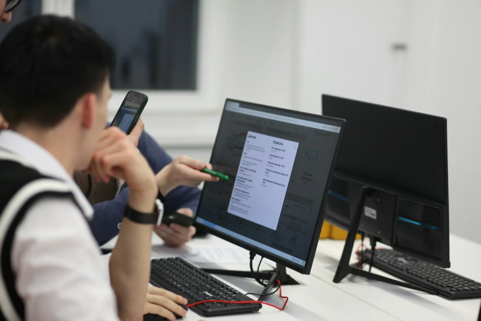 People reviewing information on a desktop screen during an AI prompt and workflow training session.