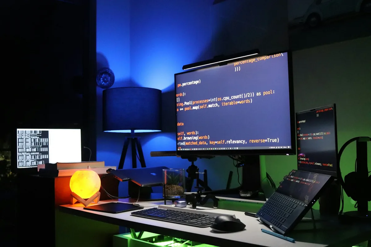 Monitoring workstation showing code and operational screens for connectivity, infrastructure and AI support.