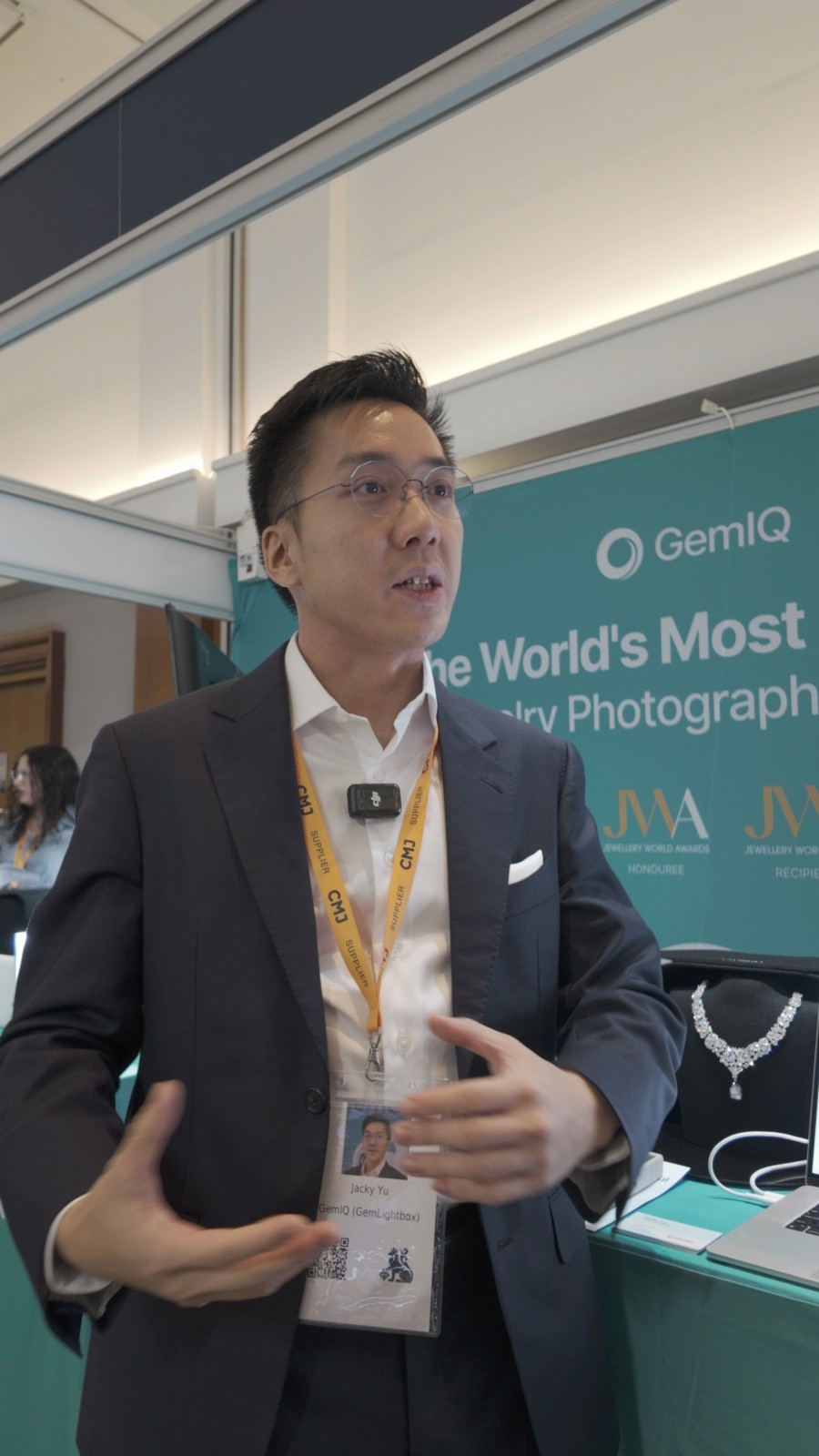 Jack Yu speaking at the GemIQ stand during his HIKOMORE interview at CMJ